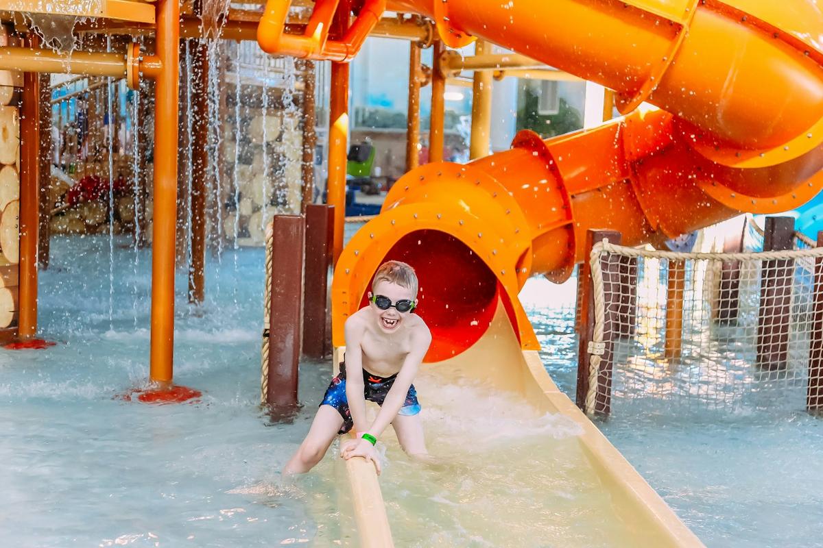 Boy splashing on a slide