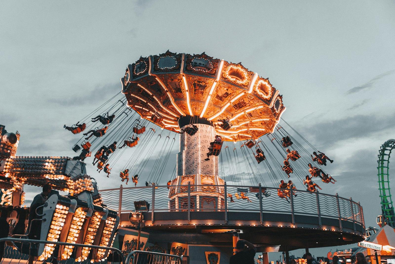 Swing ride lit up at dusk